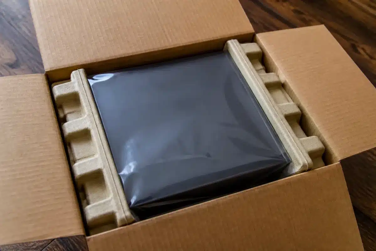 Carton ouvert révélant emballage d'origine intact et marque visible