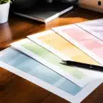 Documents comparatifs de tarifs etaleges sur table avec stylo noir