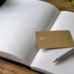 Carte bancaire posee sur un calendrier ouvert avec stylo