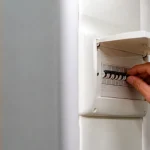 Compteur électrique mural avec main ouvrant un disjoncteur