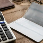 Homme age assis devant calculatrice et releve bancaire ouvert